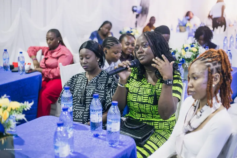 A guest asking a question with a microphone during a session at the Reform conference