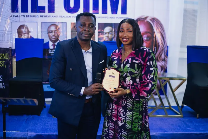 A plaque being presented on stage at the Reform conference