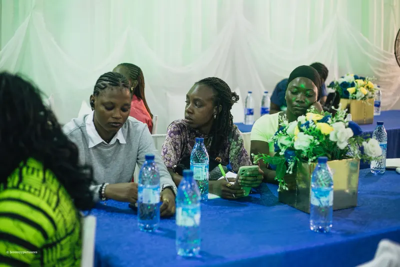Guests seated at a blue-covered table during a session at the Reform conference